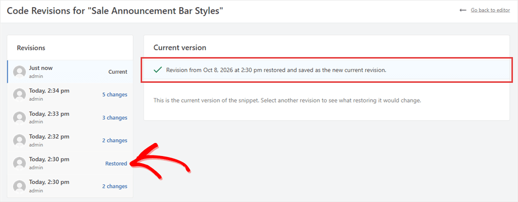 Revisions page after a restore, with the success message and the restored revision marked Restored in the list.